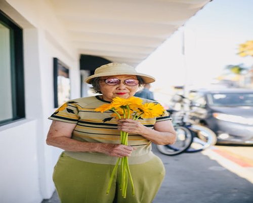 Smiling elderly woman outdoors wearing glasses